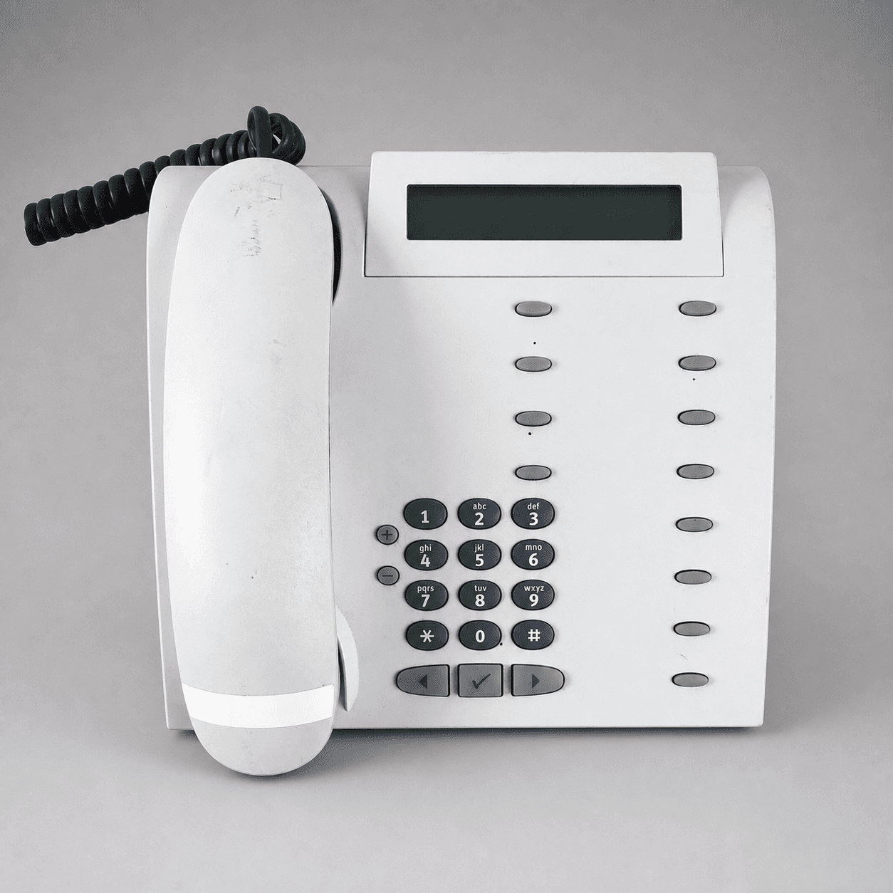 Šedý kancelářský telefon s displejem — Fotografie 1